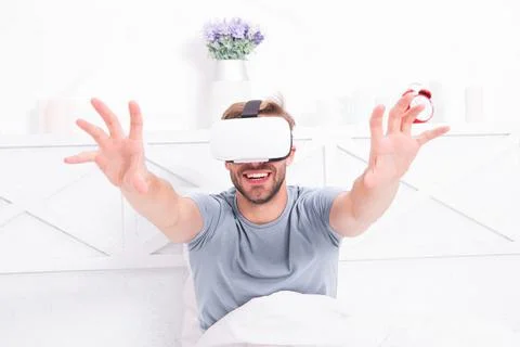 Using computer technology to create a simulated environment. Happy guy wearing Foto stock