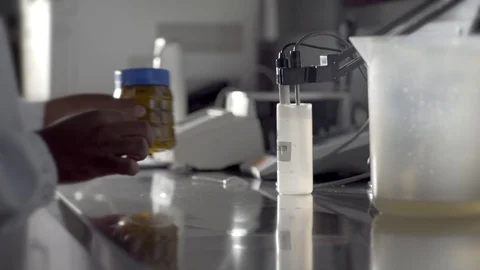 Using computerized apparatus, a food scientist checks quality in a Video stock 95555142