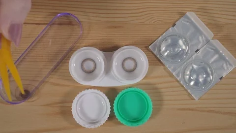 Using a container with a solution for lenses, for storing colored lenses Stock Footage 120074903