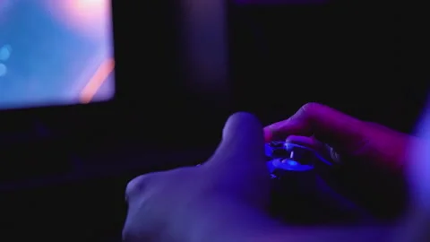 Using a Controller to Play Video Games - Hands and Joypads Stock Footage 197099618