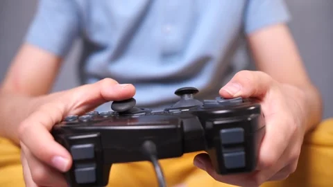 Using controller playing video games - close up of hands and joypad Stock Footage 272751520