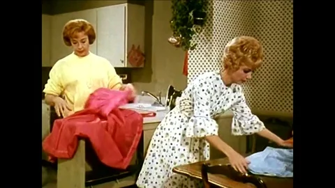 Using a cordless switchboard, a blonde receptionist connects her boss to another Video stock 95598696