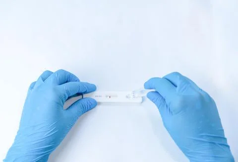 Using a covid 19 rapid test - test liquid is filled into the test cassette Stock Photos