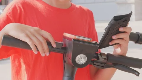 Using credit card and cellphone to unlock electric scooter Stock Footage 115200332