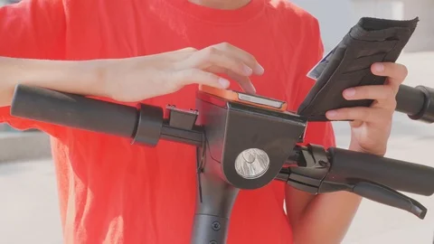 Using credit card and smartphone for electric scooter rent Stock Footage 115090023