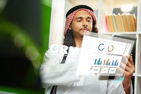 Using CRM software to analyze customer data in an office setting Stock Photos
