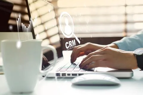 Using CRM software for customer management during work at a desk in an office Stock Photos