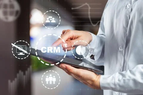Using CRM software on tablet to manage customer relationships in a modern office Stock Photos