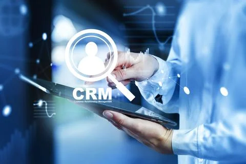 Using CRM software on a tablet to manage customer information in a business Stock Photos