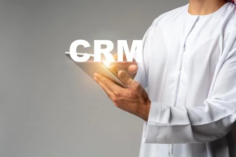 Using CRM software on tablet by a person in traditional clothing Stock Photos