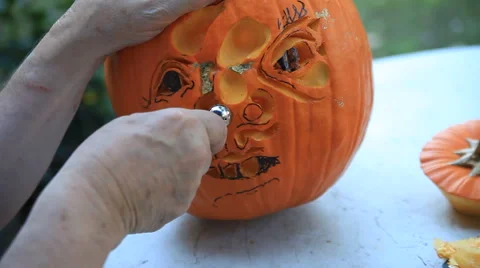 Using different tools on a Halloween pumpkin Stock Footage 56660431