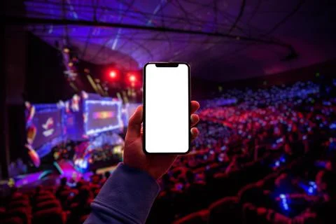 Using digital application on the mobile smart phone at esport event at big arena Stock Photos