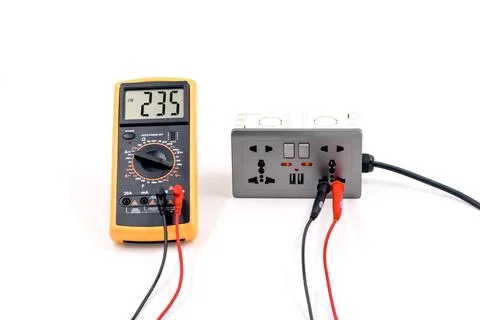 Using a digital meter to measure the voltage at a electric socket box on wh.. Stock Photos