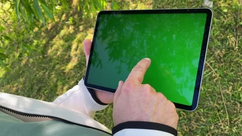 Using digital tablet while spending leisure in public park. Stock Footage 243009282