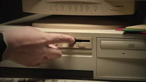 Using diskette FDD for old computer close-up. Hand inserting and ejecting Floppy Stock Footage 264938279