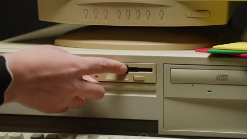Using diskette FDD for old computer close-up. Hand inserting and ejecting Floppy Stock Footage 266084874