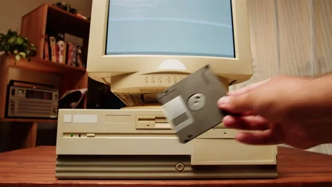 Using diskette for old computer. Music recorder, playing retro computer games Video stock 205899218