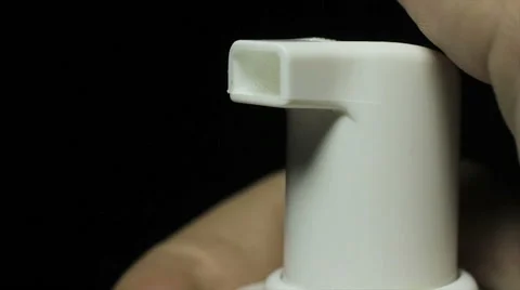 Using dispenser, closeup on dark background Vidéo 61246681