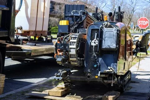 Using drilling machine is used to lay underground optical fiber buried cables Stock Photos