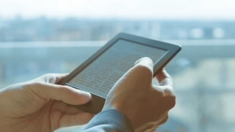 Using e-reader tablet, reading ebook Video stock 104816392