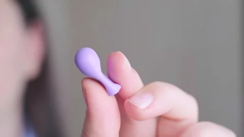 Using earplugs for sleep, promoting healthy rest and body recovery, prioritizing Stock Footage 296575769