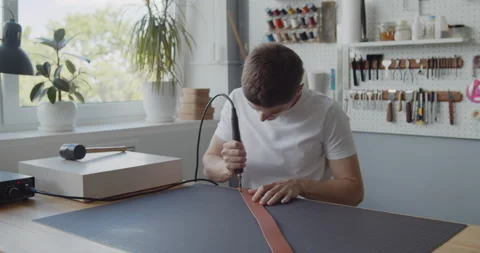 Using electric grooving iron during leather belt making process Stock Footage 144890890