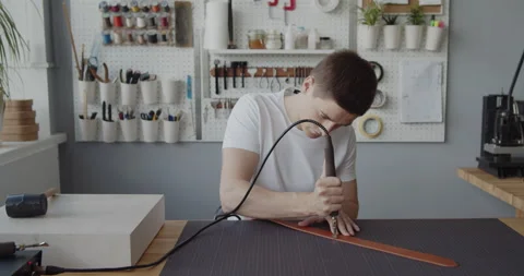 Using electric grooving iron during leather belt making process Stock Footage 146133823