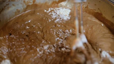 Using an electric mixer to beat chocolate or cocoa powder, baking powder Stock Footage 82453237