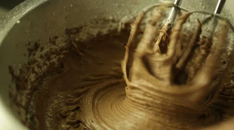Using an electric mixer to beat cocoa powder and flour Stock Footage 36781703