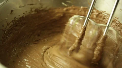 Using an electric mixer to beat cocoa powder and flour Stock Footage 36781710
