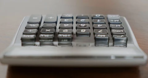 Using an electronic calculator isolated in DCI 4K Stock Footage 104656608