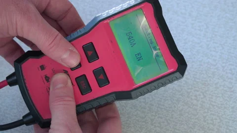 Using an electronic tester to diagnose a car battery. Indications on the di.. Stock Footage 228824754