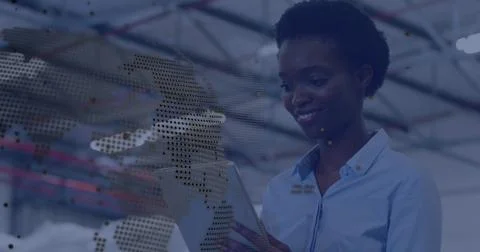 Using engineer wearing blue shirt checking tablet inside warehouse, dotted map Stock Photos