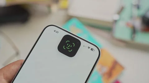 Using Face ID on an iPhone for unlocking a banking app on a smartphone Stock Footage 334016838