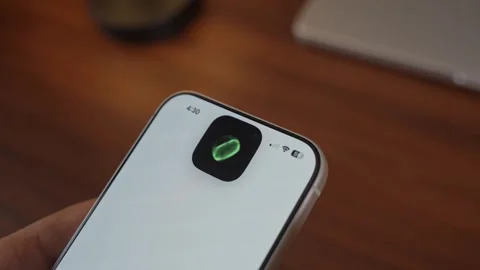 Using Face ID on an iPhone for unlocking a banking app on a smartphone Stock Footage 334016898