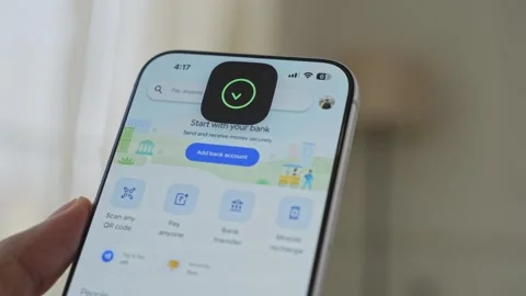 Using Face ID on an iPhone for unlocking a banking app on a smartphone Stock Footage 334016952