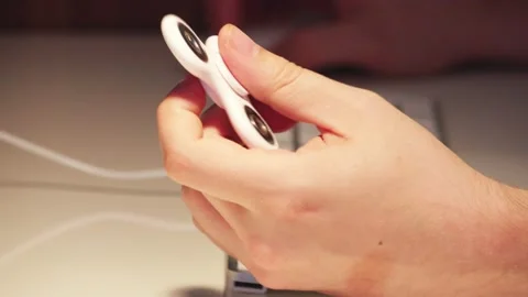 Using a fidget spinner when working on computer 2 Stock Footage 130865505