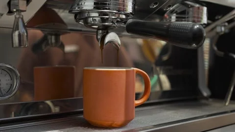 Using filter holder. Pouring coffee stream from machine in cup. Cafe making hot Video stock 285126448