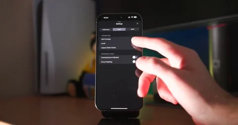 Using Final Cut Pro Settings on iPhone with Hand on Desk Stock Footage 297732496
