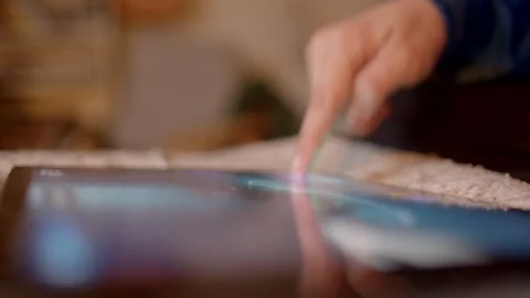 Using fingers to control the gadget closeup view of a hand that is gently tappin Stock Footage 295932362