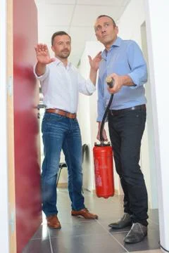 Using fire extinguisher in a office Stock Photos