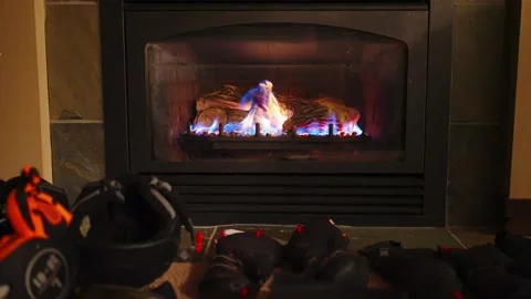 Using a fireplace to dry gloves in winter ski season Stock-Footage 145556186