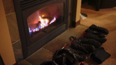 Using a fireplace to dry gloves in winter ski season Stock-Footage 145574832