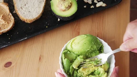 Using fork to mash avocado Stock Footage 95197465