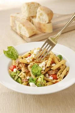 Using a fork on the penne pasta. Stock Photos