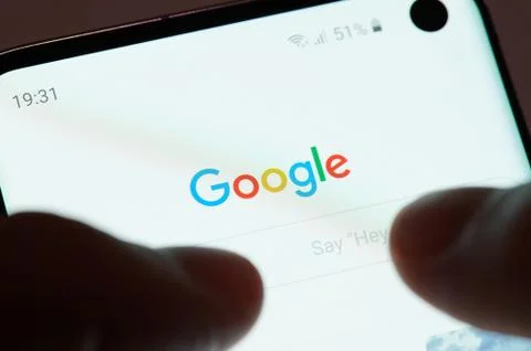 Using google app on smartphone Stock Photos