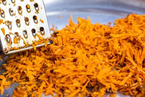 Using grater or shredder to cut turmeric roots into fine pieces for medicinal Stock Photos