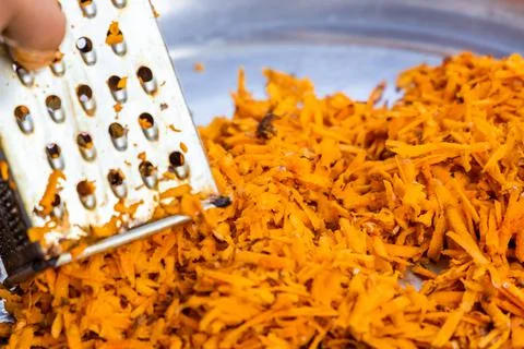 Using grater or shredder to cut turmeric roots into fine pieces for medicinal Stock Photos