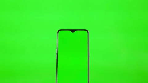 Using a Green Mobile Phone Screen on a Green Background. The Hand Touches the Ce Stock Footage 146890861