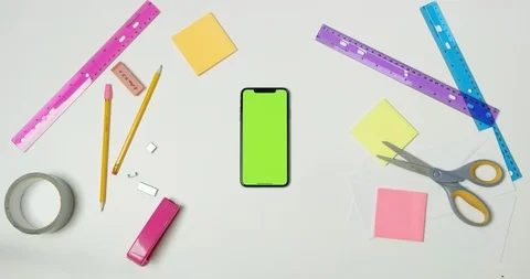 Using green screen phone on a arts and crafts white table Stock Footage 97480601